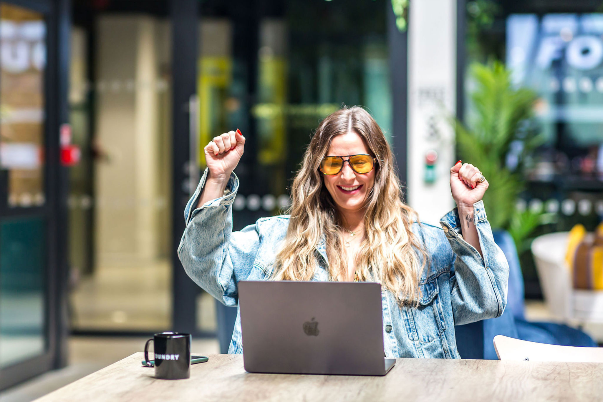 Person with hands in the air, cheering, after completing online dyslexia test - QS Dyslexia Tests